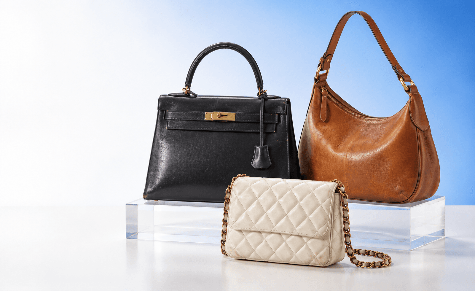 Pre-loved designer handbags in black, cognac, and ivory leather